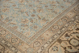 Corner detail of a distressed Tabriz showing the turtle border and low-pile Herati field.