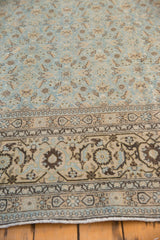 Angled view of the distressed Tabriz carpet's corner showing the turtle samovar border.
