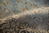 Worn, low pile and turtle samovar border detail on a distressed Persian Tabriz carpet.