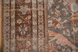 Worn texture of Mahal carpet, featuring geometric border and Gul Farang motifs in rose and pale blue.
