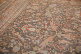 Distressed vintage Mahal carpet displaying Gul Farang rose motifs and pale blue details.