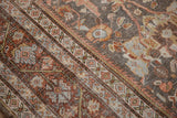 Worn Persian Mahal carpet detail, with Gul Farang rose motifs and pale blue geometric border.