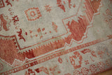Mostly even wear across the hand-knotted pile of a distressed Turkish Oushak rug.