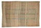 Vintage distressed Belouch carpet with geometric medallions and heavy abrasion in sky blue, brown, and sand.