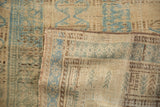 Hand-knotted back and distressed, low pile texture of a vintage Persian Belouch rug.