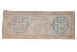 Distressed vintage Caucasian runner with three oversized medallions in sky blue, platinum, and beige tones.