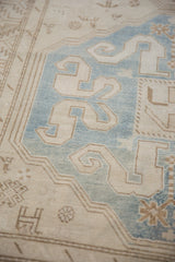 Evenly worn pile on a Caucasian rug with sky blue and platinum cloud-band arabesque motifs.