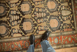 A personal view of the charcoal lattice field and rust geometric border on a vintage Mehriban rug.