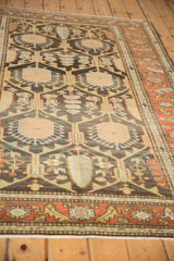 Low perspective of a vintage Mehriban rug's lattice field, highlighting the low-pile texture and even wear.