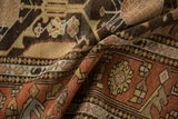 Softly folded vintage Mehriban rug with a low, textured pile and geometric border.