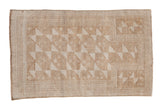 Vintage distressed Belouch rug with geometric pinwheel pattern, prayer mehrab in ivory and sand.