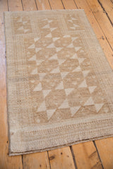 Distressed vintage Belouch rug side border with minor blossom design and even wear to pile.