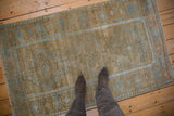 The softly worn pile of a vintage Belouch rug, featuring a powder blue pawn design motif.