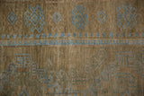 Close-up of the reciprocating pawn design motif in powder blue on the abrashed coffee brown wool pile.