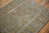 Time-softened pile of a distressed Belouch rug with a pale blue geometric pawn design motif.