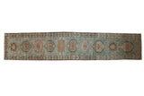 Distressed Karaja rug runner with geometric medallions in rust and bronze on a dusty powder blue field.