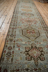 Perspective view down the length of a vintage Karaja runner with alternating geometric medallions.