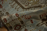 Supple, hand-knotted texture of a distressed Karaja runner in dusty blue, bronze, and rust tones.