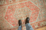 Decorative wear and time-softened texture of a vintage Malayer rug in raspberry and sky blue.