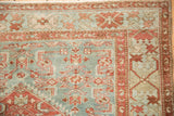 Worn texture on the crab-style floral and boteh borders of a vintage Malayer rug corner.