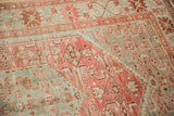 Corner spandrel detail on a distressed Malayer rug with faded raspberry and powder blue tones.