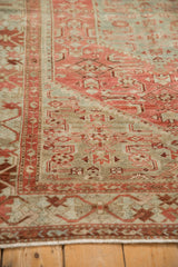 A low-angle close-up of the distressed Malayer's low pile, showing the dusty raspberry and sky blue Herati design.