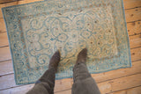 Vintage Distressed Tabriz rug texture showcasing powder blue scrolling arabesques and even wear.