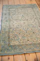 Distressed vintage Tabriz rug with powder blue scrolling vines and pawn border.