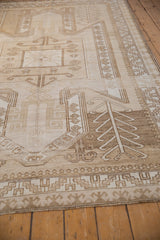 Angled view of a Kars carpet's low-pile texture and geometric ram's horn motifs in beige.