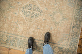 Low pile of a distressed Karaja rug showing even wear to the knot heads in sand and dusty teal.