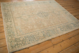 Low angle view across a distressed vintage Karaja rug, highlighting its muted, earthy palette.