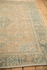 Angled perspective showing the low, even pile of a distressed Persian Karaja rug.
