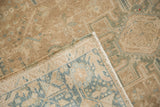 Folded corner on a vintage Karaja rug showing the hand-knotted back and distressed pile texture.