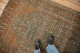 Standing view of the distressed texture and Herati pattern on a vintage Persian Malayer rug.