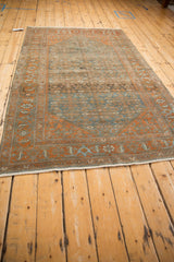 Full perspective of a vintage Malayer rug, highlighting the abrashes in its dusty blue and rust palette.
