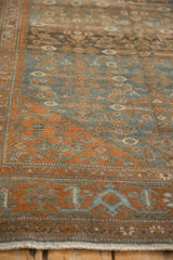 Angled close-up of a vintage Malayer rug's time-softened texture and Herati Samovar border.