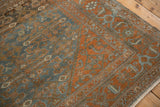 Stylized Samovar motif in the madder rust border of a distressed vintage Malayer rug.