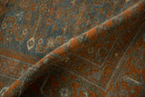 A soft fold displaying the mostly even wear and low pile on this distressed Malayer rug.