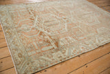 Angled view showing the distressed low pile and central medallion of a vintage Persian Malayer rug.