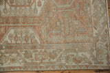 Detail of the distressed texture and serrated vine border in terracotta and silver.