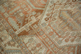 Worn hand-knotted pile of a Persian Malayer showing terracotta and dusty blue patterns.