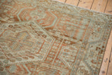 Serrated vine border and distressed, low-pile texture on a vintage Persian Malayer rug.