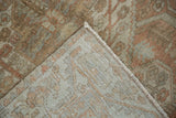 The hand-knotted foundation and distressed pile of a vintage Persian Malayer rug's corner.