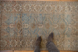 Distressed Persian Belouch runner showcasing geometric diamond motifs, abrashes, and mixed dusty tones.