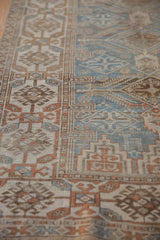 Distressed Belouch runner showing worn geometric motifs, dusty blue and terra cotta texture.