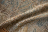 Distressed vintage Belouch runner pile, showing softened diamond motifs in dusty powder blue and coffee brown.