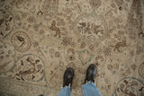 Distressed vintage Tabriz rug with ivory hunting scene, birds, lions, and cypress trees.