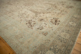 Distressed pale blue and coffee brown hunting scene motifs on vintage Tabriz carpet.