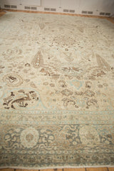 Distressed texture and hunting scene motifs with pheasants on a vintage Tabriz carpet.