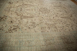 Distressed ivory and pale blue Tabriz border and field with birds and palmette motifs.